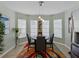 Cozy dining area featuring a round table with unique lighting and large windows overlooking the yard at 1338 Winding Willow Dr, Trinity, FL 34655