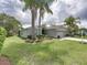 Inviting single-Gathering home featuring a manicured lawn and mature trees at 1338 Winding Willow Dr, Trinity, FL 34655