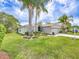 Charming single-story home with well-maintained lawn, lush landscaping, and attached two-car garage at 1338 Winding Willow Dr, Trinity, FL 34655