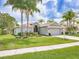 Charming single-story home with well-manicured lawn, mature landscaping, and a two-car garage at 1338 Winding Willow Dr, Trinity, FL 34655