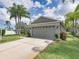 Well-maintained home with a large two-car garage and a neatly landscaped yard at 1338 Winding Willow Dr, Trinity, FL 34655