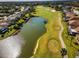 Expansive golf course with lush green fairways, a serene pond, and well-manicured greens surrounded by beautiful homes at 1338 Winding Willow Dr, Trinity, FL 34655
