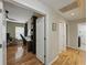 Inviting hallway leading to a home office, showcasing hardwood floors and modern finishes at 1338 Winding Willow Dr, Trinity, FL 34655