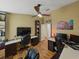 Multi-workstation home office featuring hardwood floors, ceiling fan, and comfortable seating at 1338 Winding Willow Dr, Trinity, FL 34655