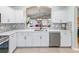 Bright kitchen features white cabinets, stainless appliances, and an open view to the living space at 1338 Winding Willow Dr, Trinity, FL 34655