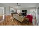 Bright and airy living room with hardwood floors open to dining and kitchen at 1338 Winding Willow Dr, Trinity, FL 34655