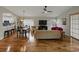 Spacious living room features hardwood floors, a vaulted ceiling, and modern furnishings with plenty of natural light at 1338 Winding Willow Dr, Trinity, FL 34655