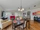 Spacious living room open to dining area, filled with natural light and wood floors at 1338 Winding Willow Dr, Trinity, FL 34655