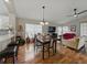 Comfortable living room open to dining space with wood floors and ample sunlight at 1338 Winding Willow Dr, Trinity, FL 34655