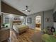 Relaxing primary bedroom boasts vaulted ceilings, wood floors, and ensuite bathroom access at 1338 Winding Willow Dr, Trinity, FL 34655
