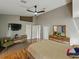Relaxing main bedroom with a ceiling fan, sitting area, ensuite, and plenty of natural light at 1338 Winding Willow Dr, Trinity, FL 34655