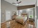 Bright main bedroom with wood floors, lots of light, and access to outdoor patio at 1338 Winding Willow Dr, Trinity, FL 34655