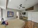 Spacious main bedroom featuring hardwood floors, ceiling fan, walk-in closet, and en-suite bathroom at 1338 Winding Willow Dr, Trinity, FL 34655