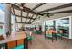 Elegant covered outdoor patio features dining tables and ceiling fans for a comfortable dining experience with scenic views at 1338 Winding Willow Dr, Trinity, FL 34655