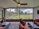 Relaxing screened patio with stylish outdoor furniture, offering a peaceful view of the lawn at 1338 Winding Willow Dr, Trinity, FL 34655