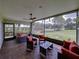 Relaxing screened patio with stylish outdoor furniture, offering a peaceful view of the lawn at 1338 Winding Willow Dr, Trinity, FL 34655