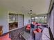 Relaxing screened patio with stylish outdoor furniture, offering a peaceful view of the lawn at 1338 Winding Willow Dr, Trinity, FL 34655