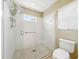 Clean bathroom shower with white tiles and a glass door, creating a modern and spacious feel at 1338 Winding Willow Dr, Trinity, FL 34655