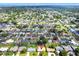 Wide aerial shot of a tranquil neighborhood with a mix of single-Gathering homes surrounded by mature trees at 13795 Antigua Dr, Seminole, FL 33776