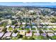 Expansive aerial view of a residential neighborhood near the coast with lush greenery and a clear blue sky at 13795 Antigua Dr, Seminole, FL 33776