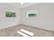 Bright bedroom featuring two windows and plush carpeting, perfect for relaxation and comfort at 13795 Antigua Dr, Seminole, FL 33776