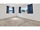 Bright bedroom with carpet flooring, two windows, and neutral walls and curtains at 13795 Antigua Dr, Seminole, FL 33776