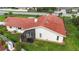 Overhead view of the home featuring a red-tiled roof, screened enclosure, and well-kept lawn at 1414 75Th Nw St, Bradenton, FL 34209