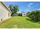 Large, grassy backyard featuring a shed, landscaping, and an enclosed patio at 1414 75Th Nw St, Bradenton, FL 34209