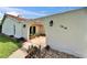 A beautifully lit entrance to a home featuring a courtyard with an arched entryway and landscaped surroundings at 1414 75Th Nw St, Bradenton, FL 34209