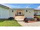 Exterior entrance through an archway, displaying a well-kept courtyard with landscaping and a partial view of the home at 1414 75Th Nw St, Bradenton, FL 34209