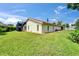 Home exterior with a tile roof, screened in lanai, and green lawn at 1414 75Th Nw St, Bradenton, FL 34209