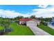 Charming home featuring a red tile roof and well-manicured lawn at 1414 75Th Nw St, Bradenton, FL 34209