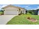 Home exterior showcasing a two-car garage, black metal fence, and landscaping at 1414 75Th Nw St, Bradenton, FL 34209
