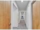 Hallway with carpeted floors, white walls, and multiple doors at 1414 75Th Nw St, Bradenton, FL 34209