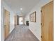 Hallway with grey carpet, white walls, and wooden doors leading to other areas of the home at 1414 75Th Nw St, Bradenton, FL 34209