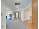 Bright hallway with gray carpet and white walls leads to other rooms with hardwood floors at 1414 75Th Nw St, Bradenton, FL 34209
