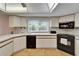 Traditional kitchen features appliances, tile flooring, and view to outside at 1414 75Th Nw St, Bradenton, FL 34209