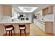 Bright kitchen features white cabinets, barstool seating, and ceiling fan at 1414 75Th Nw St, Bradenton, FL 34209