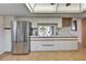 Bright kitchen with stainless steel appliances, white cabinets, and tile flooring at 1414 75Th Nw St, Bradenton, FL 34209