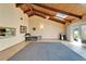 Open living room with high ceilings, wood beams, skylights, tile flooring, and sliding glass doors at 1414 75Th Nw St, Bradenton, FL 34209