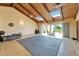 Bright living room featuring high ceilings with wood beams and skylights, and access to the outdoors at 1414 75Th Nw St, Bradenton, FL 34209