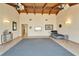 Spacious living area with high ceilings, wood beams, neutral walls, and tile flooring throughout at 1414 75Th Nw St, Bradenton, FL 34209
