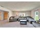 Spacious living room with grey sofa, large windows, and natural light creating an open atmosphere at 1414 75Th Nw St, Bradenton, FL 34209
