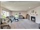 Bright living room features a fireplace, large sofa, and natural light from the window at 1414 75Th Nw St, Bradenton, FL 34209