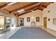 Bright living area featuring a high ceiling with wood beams, skylights, and tile flooring throughout at 1414 75Th Nw St, Bradenton, FL 34209