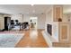 Open living space featuring hardwood floors, modern lighting, fireplace and view of kitchen area at 1414 75Th Nw St, Bradenton, FL 34209