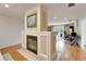 Open living space showcasing a fireplace feature, hardwood floors, and access to outdoor area at 1414 75Th Nw St, Bradenton, FL 34209