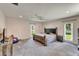 Spacious main bedroom with carpet, ceiling fan, and natural light from the windows at 1414 75Th Nw St, Bradenton, FL 34209