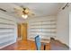 Bright office space featuring built-in shelves, a ceiling fan, and hardwood floors at 1414 75Th Nw St, Bradenton, FL 34209