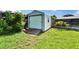 Backyard featuring a storage shed, lush grass, and some shade at 1414 75Th Nw St, Bradenton, FL 34209